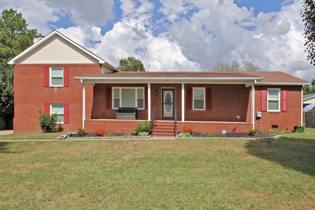 tri-level home with a porch and a front yard