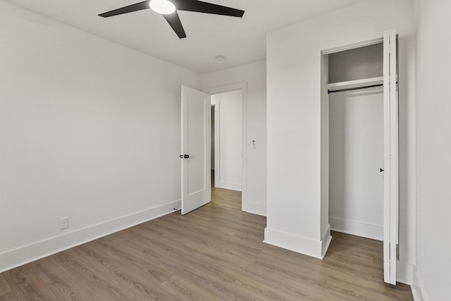 unfurnished bedroom featuring ceiling fan, a closet, and light hardwood / wood-style floors