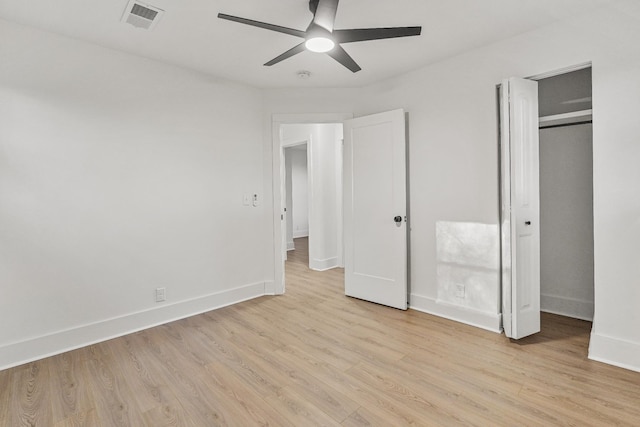 unfurnished bedroom featuring ceiling fan, a closet, and light hardwood / wood-style floors