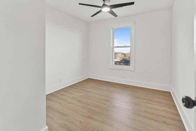 spare room with ceiling fan and light wood-type flooring