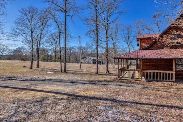 view of yard featuring covered porch