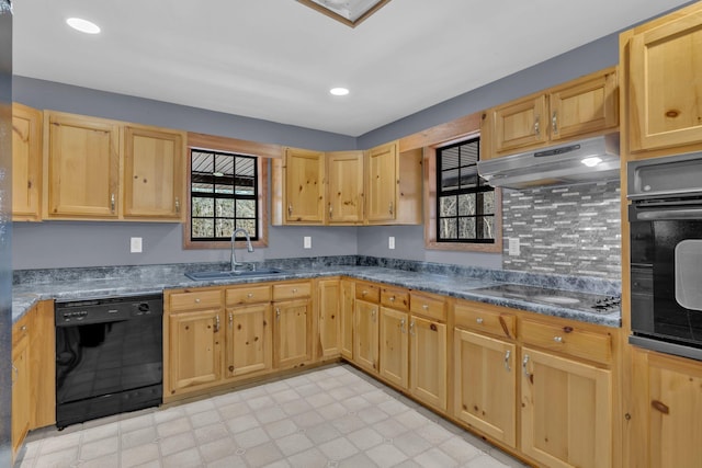 kitchen with sink, light brown cabinets, dark stone counters, and black appliances