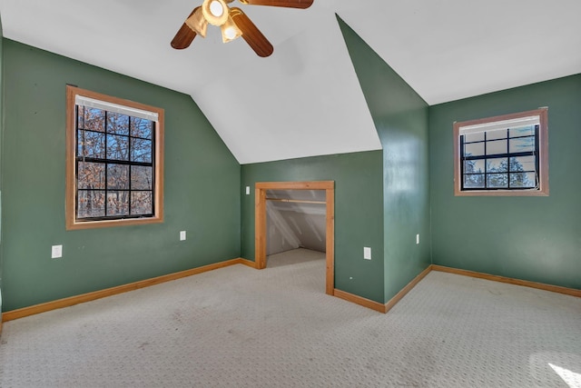 additional living space featuring light carpet, vaulted ceiling, and ceiling fan