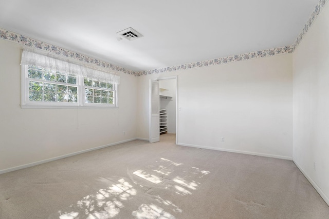 unfurnished room featuring light colored carpet