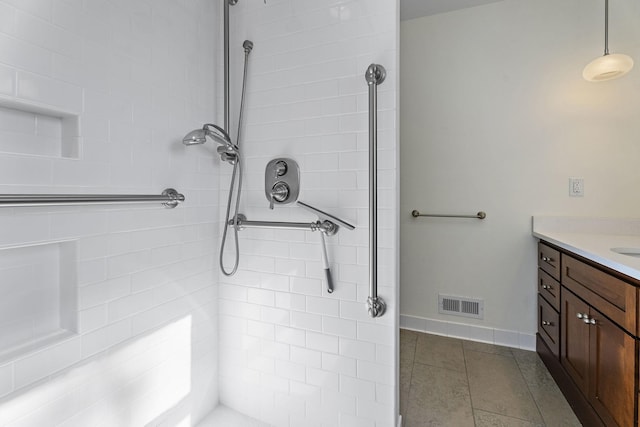 bathroom featuring vanity and a tile shower