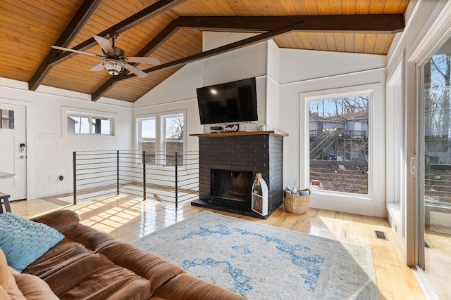 living room featuring a fireplace, lofted ceiling with beams, wood ceiling, and light hardwood / wood-style floors