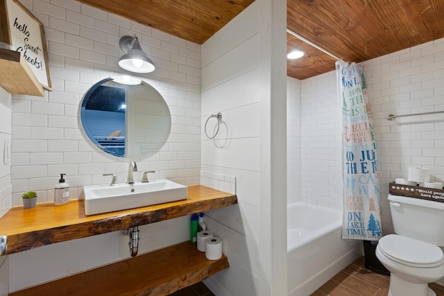 full bathroom featuring shower / bath combo with shower curtain, sink, tile walls, and wood ceiling