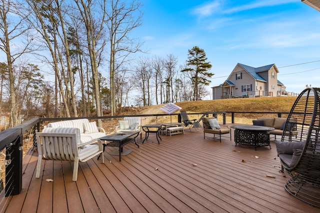 wooden terrace featuring outdoor lounge area