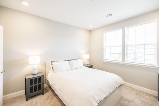 bedroom featuring light colored carpet