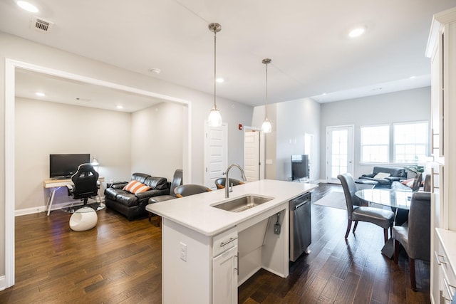 kitchen featuring white cabinetry, stainless steel dishwasher, decorative light fixtures, and sink