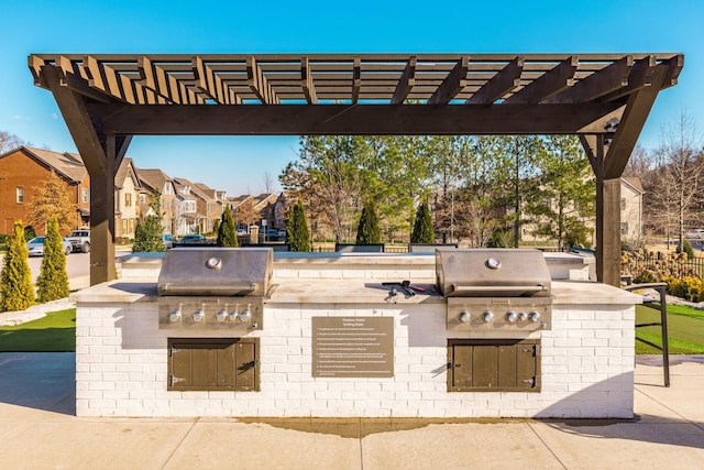 view of patio / terrace featuring grilling area, a pergola, and exterior kitchen