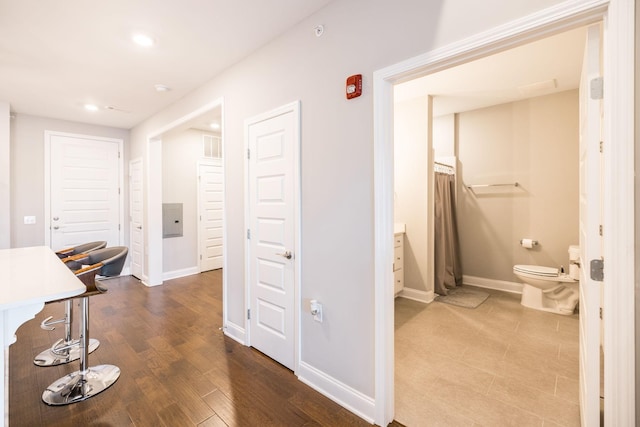 hallway with hardwood / wood-style floors