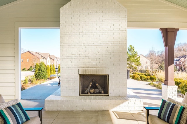 view of patio with an outdoor brick fireplace