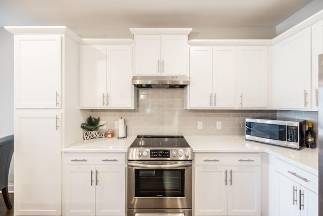 kitchen featuring decorative backsplash, appliances with stainless steel finishes, and white cabinetry