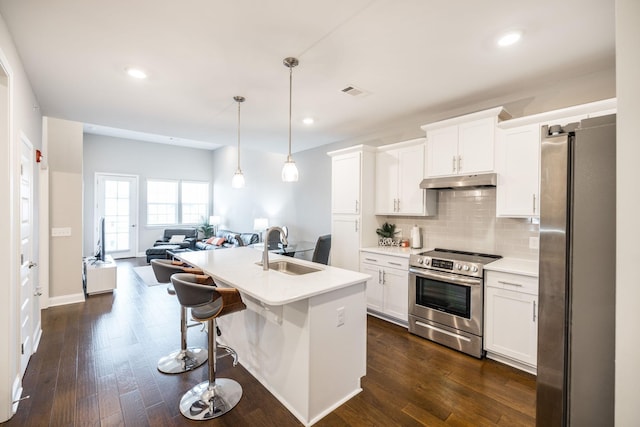 kitchen with stainless steel appliances, pendant lighting, white cabinets, and sink