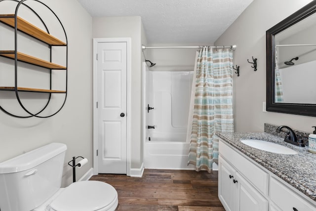 full bathroom featuring toilet, shower / tub combo, a textured ceiling, wood-type flooring, and vanity