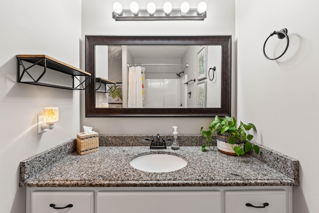 bathroom featuring curtained shower and vanity