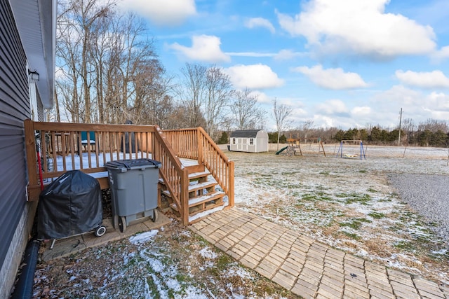 view of yard featuring a storage shed and a deck