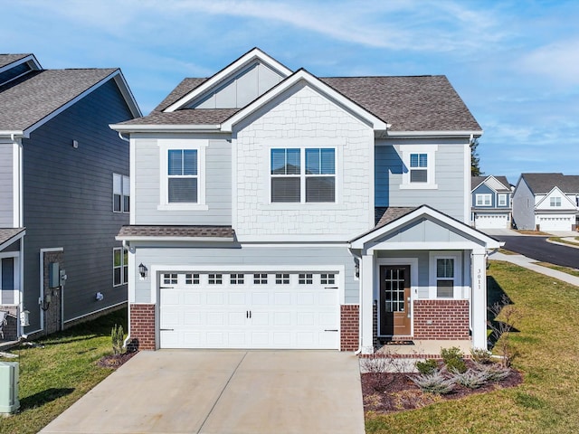 view of front of property featuring a garage and a front lawn