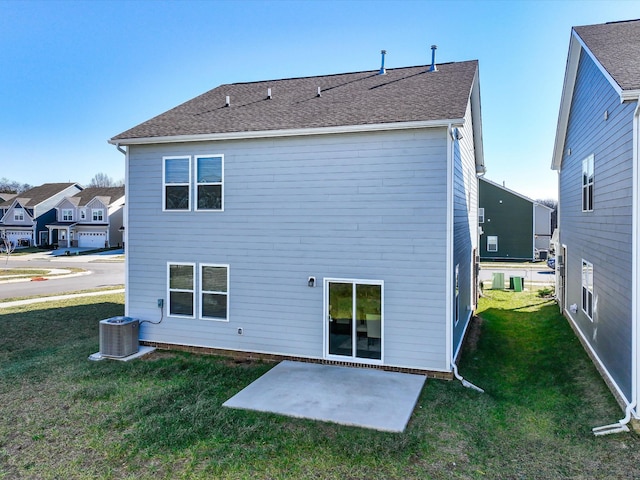 rear view of property with a lawn, cooling unit, and a patio area