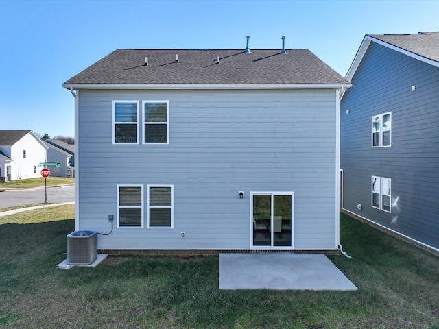 rear view of property with central AC unit, a patio area, and a lawn