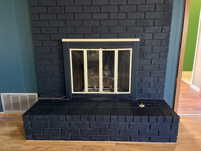 room details featuring a fireplace and hardwood / wood-style floors