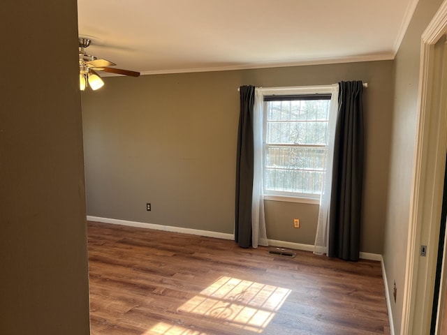 unfurnished room with ceiling fan, hardwood / wood-style floors, and crown molding