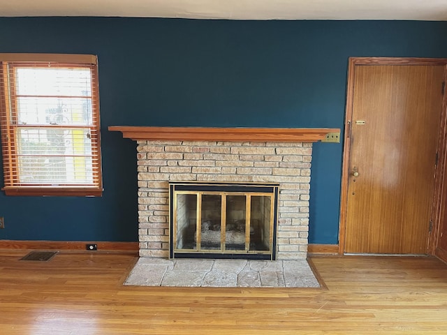 room details featuring hardwood / wood-style flooring and a brick fireplace