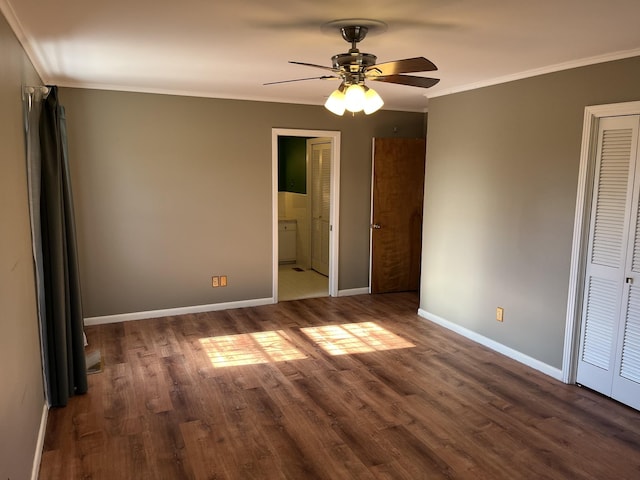 unfurnished bedroom with ceiling fan, ensuite bathroom, dark hardwood / wood-style flooring, and ornamental molding