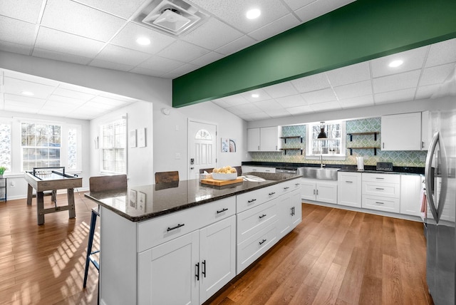 kitchen featuring white cabinets, wood-type flooring, and sink