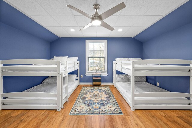 bedroom featuring ceiling fan, vaulted ceiling, and hardwood / wood-style floors