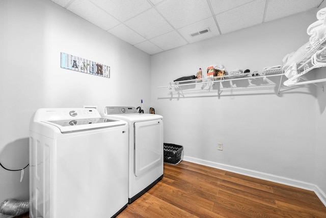 washroom featuring hardwood / wood-style floors and washing machine and dryer