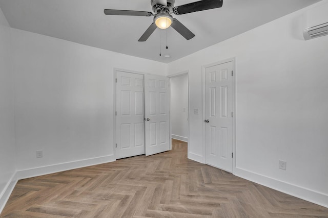 unfurnished bedroom featuring a wall unit AC, ceiling fan, and light parquet flooring