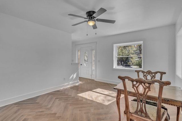 living area with ceiling fan and parquet flooring