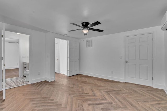 unfurnished bedroom featuring ceiling fan, parquet flooring, and ensuite bathroom