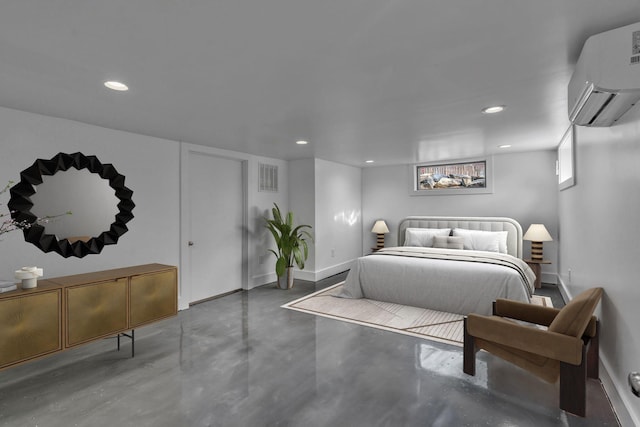 bedroom featuring concrete floors and an AC wall unit