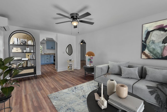 living room with ceiling fan, dark hardwood / wood-style floors, and a wall mounted AC