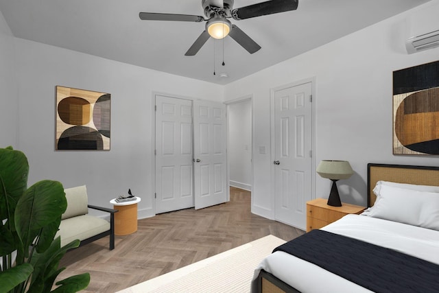 bedroom featuring ceiling fan, light parquet floors, and a wall unit AC