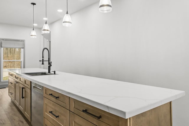 kitchen with sink, hanging light fixtures, light stone countertops, a center island with sink, and stainless steel dishwasher