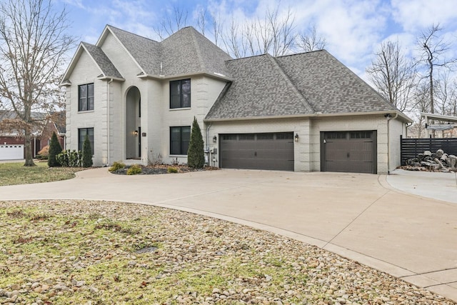 french country inspired facade featuring a garage