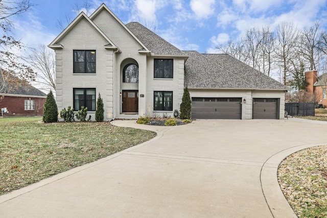 view of front facade with a garage and a front lawn