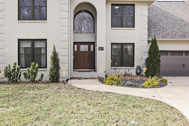 doorway to property with a lawn