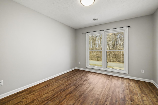 unfurnished room featuring dark hardwood / wood-style flooring