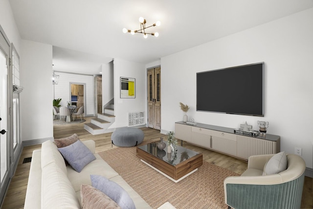 living room featuring an inviting chandelier and hardwood / wood-style flooring