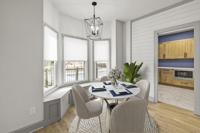 dining space featuring a chandelier and light hardwood / wood-style flooring