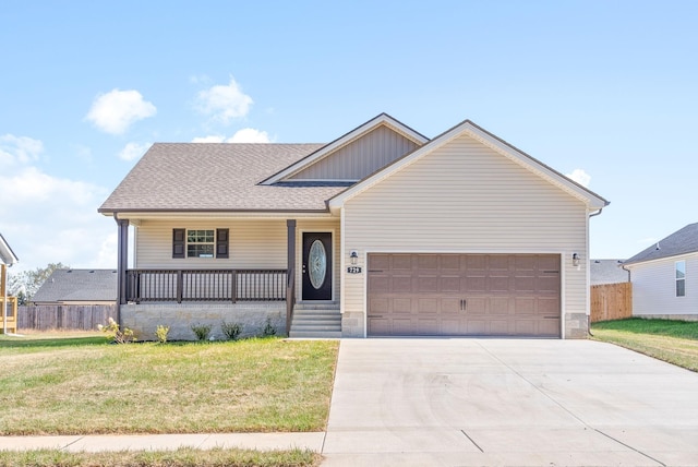 view of front of property with covered porch, a front lawn, and a garage