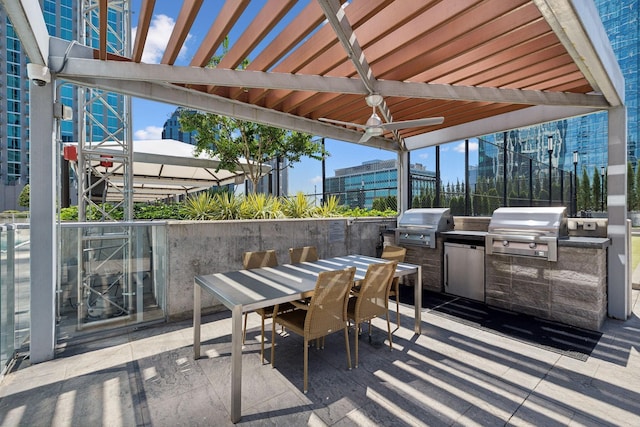 view of patio with grilling area, ceiling fan, and exterior kitchen