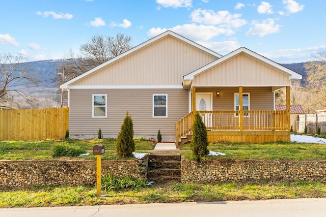 view of front of home with covered porch and a mountain view