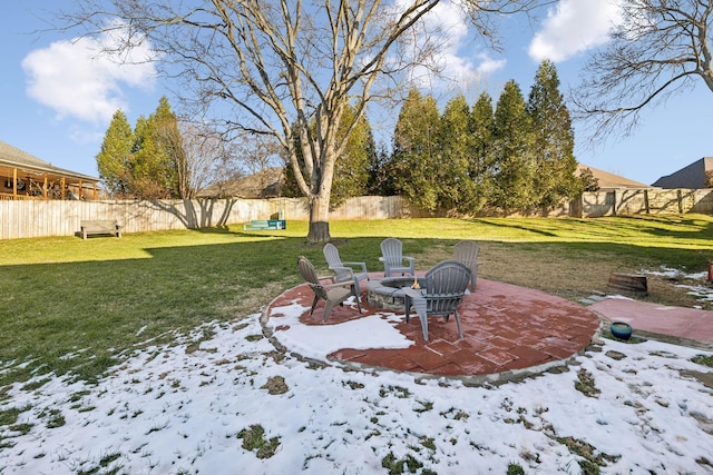 snowy yard featuring an outdoor fire pit and a patio