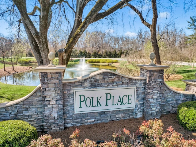 community sign with a water view